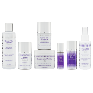A set of seven skincare products designed for normal to combination skin, including Green Tea Citrus Cleanser, Retinol 2% Exfoliating Scrub, Glycolic Retinol Pads, Cucumber Hydration Toner, Vitamin C/Green Tea Serum, Peptide Eye Serum, and Cacteen Balancing Moisturizer. The products are arranged in a row with sleek white, silver, and purple packaging, highlighting their exfoliating, hydrating, and protective benefits