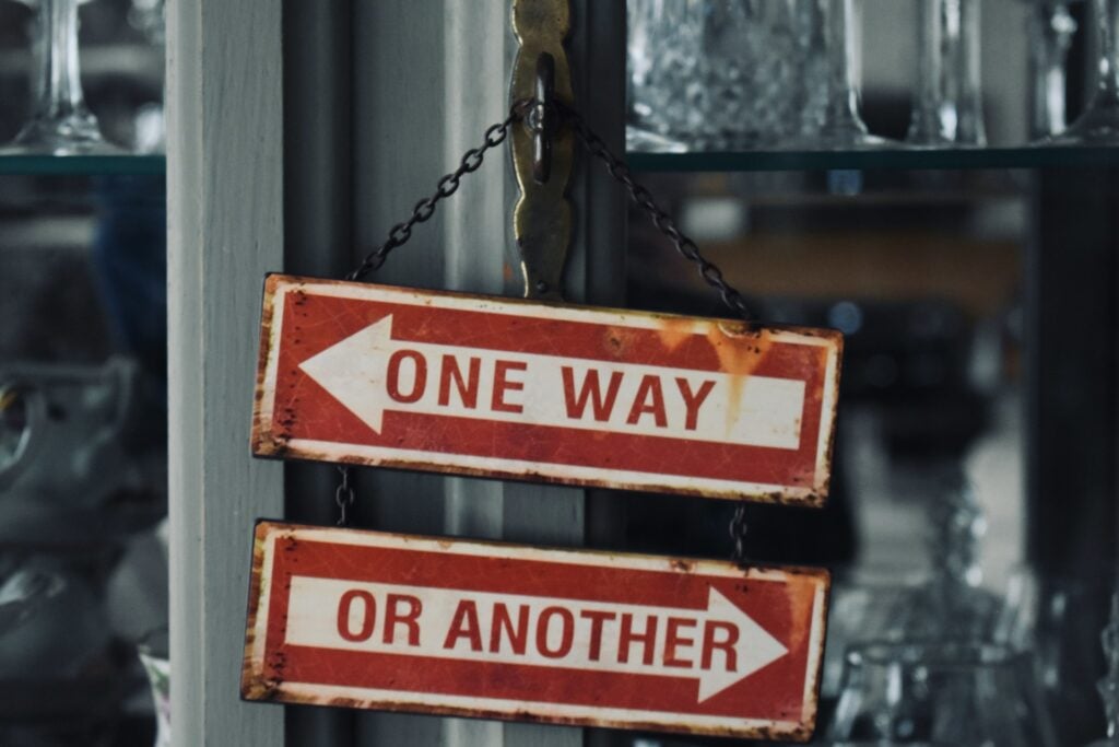 Vintage "One Way or Another" directional signs representing how people tired of helping others often blame recipients instead of examining their own boundaries and resentment.